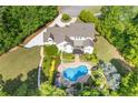 Stunning aerial view of the home showcasing the pool, patio, landscaping, and circular driveway at 110 Hawks Bnd, Canton, GA 30115