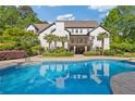 Enjoy this backyard pool and deck with tropical landscaping at 110 Hawks Bnd, Canton, GA 30115