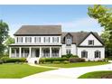 Charming two-story home with a welcoming front porch and manicured lawn, radiating curb appeal at 110 Hawks Bnd, Canton, GA 30115
