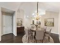 Elegant dining room with dark wood floors, chandelier, and circular rug at 15104 Harvest Ridge Ln, Alpharetta, GA 30022