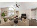 Inviting living room with fireplace, vaulted ceiling, neutral colors, and hardwood flooring at 15104 Harvest Ridge Ln, Alpharetta, GA 30022