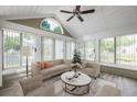 Bright sunroom with vaulted ceilings, large windows, and neutral decor, perfect for relaxation at 15104 Harvest Ridge Ln, Alpharetta, GA 30022
