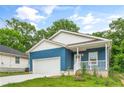 Charming blue home with a welcoming front porch and a two-car attached garage at 1924 Browns Mill Se Rd, Atlanta, GA 30315
