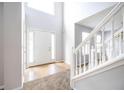 Bright foyer featuring tiled flooring, a staircase with white railing, and a soaring ceiling at 4230 Waldrop Hills Ter, Decatur, GA 30034