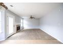 Bright living room featuring carpeted floors, fireplace, and a walk-out to the yard at 4230 Waldrop Hills Ter, Decatur, GA 30034