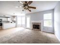Cozy living room featuring carpeted floors, fireplace, and seamless open floorplan at 4230 Waldrop Hills Ter, Decatur, GA 30034