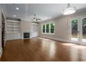 Spacious living room featuring hardwood floors, built-in shelves, and a cozy fireplace at 4900 Kentwood Dr, Marietta, GA 30068