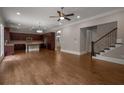 Open-concept living area with hardwood floors, adjacent to a gourmet kitchen and staircase at 4900 Kentwood Dr, Marietta, GA 30068