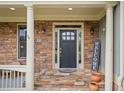 Elegant entryway with stone steps, a welcoming welcome sign, and beautiful accents at 7505 Antique Barn Ave, Cumming, GA 30041