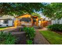 Delightful home boasts a cozy porch, beautiful landscaping, and a brick walkway, enhancing its curb appeal at 625 Kennesaw Ave, Atlanta, GA 30308