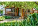Charming covered front porch with wood accents, stone steps, and beautifully landscaped surroundings at 625 Kennesaw Ave, Atlanta, GA 30308