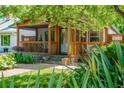 Charming covered front porch with wood accents, stone steps, and beautifully landscaped surroundings at 625 Kennesaw Ave, Atlanta, GA 30308