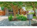 Home featuring a covered front porch, wood accents, horizontal fence, and a lush front yard at 625 Kennesaw Ave, Atlanta, GA 30308