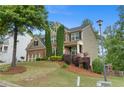 Two-story home with brick and siding, manicured lawn, and attached two-car garage at 6250 Vista Crossing Way, Cumming, GA 30028