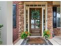 Inviting front entrance featuring a decorative wreath, stone facade, and a 'Welcome Home' doormat at 6250 Vista Crossing Way, Cumming, GA 30028