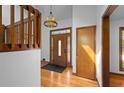 View of the foyer with hardwood flooring, a decorative front door with stained glass and a wood staircase with open risers at 1498 Camp Point Ne Ct, Roswell, GA 30075