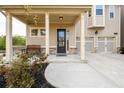 Welcoming front entrance features a covered porch, seating, and manicured landscaping at 2080 Abbey Rd, Roswell, GA 30076