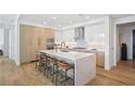 A modern kitchen with an island, stainless steel appliances, and sleek white and wood cabinets at 2425 Peachtree Rd # 508, Atlanta, GA 30305