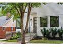 A stylish modern house featuring neat landscaping and a contemporary black-framed glass front door at 520 Wabash Ne Ave, Atlanta, GA 30312