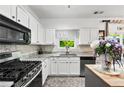 Modern kitchen featuring white cabinets, stainless steel appliances, and plenty of counter space at 1914 Lakeshore Overlook Nw Cir, Kennesaw, GA 30152