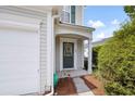 Inviting front entryway with a charming door, wreath, and well-maintained landscaping at 212 Regent Sq, Woodstock, GA 30188