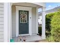 Close up on an inviting front door with wreath and stylish welcome mat and address number at 212 Regent Sq, Woodstock, GA 30188