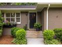 Inviting front entrance with stylish door, complemented by lush greenery and decorative accents, creating a warm welcome at 2469 Elizabeth Ann Ne Ln, Atlanta, GA 30324