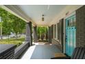 Covered front porch with brick columns, comfortable seating, and a tranquil outdoor space at 416 2Nd Ave, Decatur, GA 30030