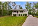 Well-maintained one-story home featuring a cozy front porch and lush green lawn at 1094 Plantation Ct, Villa Rica, GA 30180
