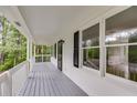 Inviting covered porch with white railings and ample space for outdoor seating at 1094 Plantation Ct, Villa Rica, GA 30180
