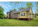 Well-maintained home showcasing brick and vinyl siding, updated windows, and a green lawn at 4050 Old Fairburn Rd, Atlanta, GA 30349