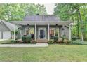 Charming home with a covered porch and a well-manicured lawn at 4490 Highway 138 Sw, Stockbridge, GA 30281