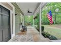 Relaxing front porch with swing and rocking chair, perfect for enjoying the outdoors at 4490 Highway 138 Sw, Stockbridge, GA 30281