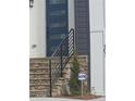 Close up of the stone steps with black railings that lead to the front door and a visible security sign at 503 Glendale Rd, Scottdale, GA 30079