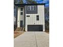 Modern two-story home with black trimmed windows and a black garage door at 503 Glendale Rd, Scottdale, GA 30079