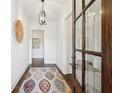 Bright foyer featuring hardwood floors, a decorative rug, and stylish light fixture at 5695 Overlook Station Dr, Suwanee, GA 30024