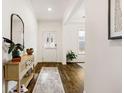 Bright foyer with hardwood floors, a stylish console table, and a view into the adjacent living spaces at 1180 Trident Maple, Lawrenceville, GA 30045