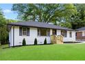 View of the landscaped front yard and exterior of a charming home with newly installed siding at 2805 Long Way, Decatur, GA 30032