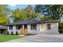 Landscaped front yard and painted brick exterior of the renovated, single-story residence at 2805 Long Way, Decatur, GA 30032