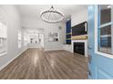 Bright living room featuring high ceilings, modern lighting, and fireplace at 5863 Landers Loop, Fairburn, GA 30213