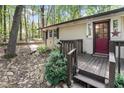 Charming red door and wood porch railings add to the cozy curb appeal at 103 Campground School Rd, Dallas, GA 30157