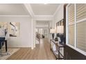 Inviting foyer with hardwood floors, elegant lighting, and an open view of the staircase at 115 Maplewood Ln, Conyers, GA 30094