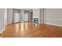 Bright living room featuring hardwood floors, fireplace, and door to balcony at 1215 Comet View Se Trl, Smyrna, GA 30082
