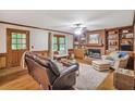 Comfortable living room with fireplace, built-in shelving, and hardwood floors at 435 Trammell Dr, Alpharetta, GA 30009