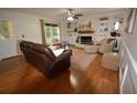 Bright living room featuring a fireplace with white built-ins, hardwood floors, and ample seating at 435 Trammell Dr, Alpharetta, GA 30009