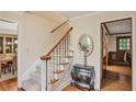 View of carpeted staircase with wooden railing, complemented by decorative furniture and hardwood flooring at 435 Trammell Dr, Alpharetta, GA 30009