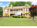 Charming two-story home featuring a welcoming front porch, landscaped yard, and a warm, inviting facade at 55 Cross Pointe Ct, Hiram, GA 30141