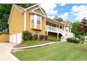 Charming two-story home featuring a welcoming front porch, landscaped yard, and a warm, inviting facade at 55 Cross Pointe Ct, Hiram, GA 30141