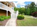 Beautiful landscaped yard and walkway leading to a charming two-story home featuring a welcoming front porch at 55 Cross Pointe Ct, Hiram, GA 30141