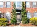Elegant home featuring a front door flanked by lush greenery and classic brick architecture at 601 Hexham Ct, Suwanee, GA 30024